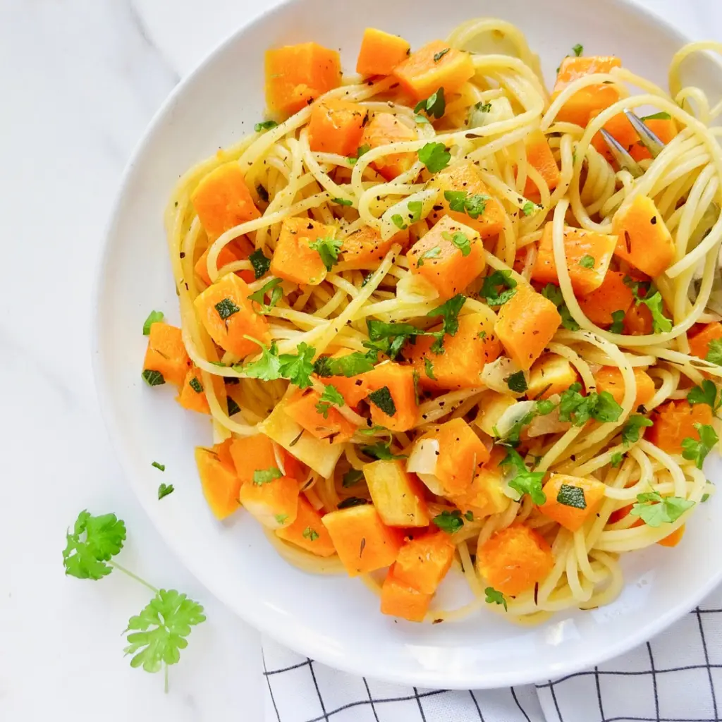brown butter and sage butternut squash pasta on a white plate.