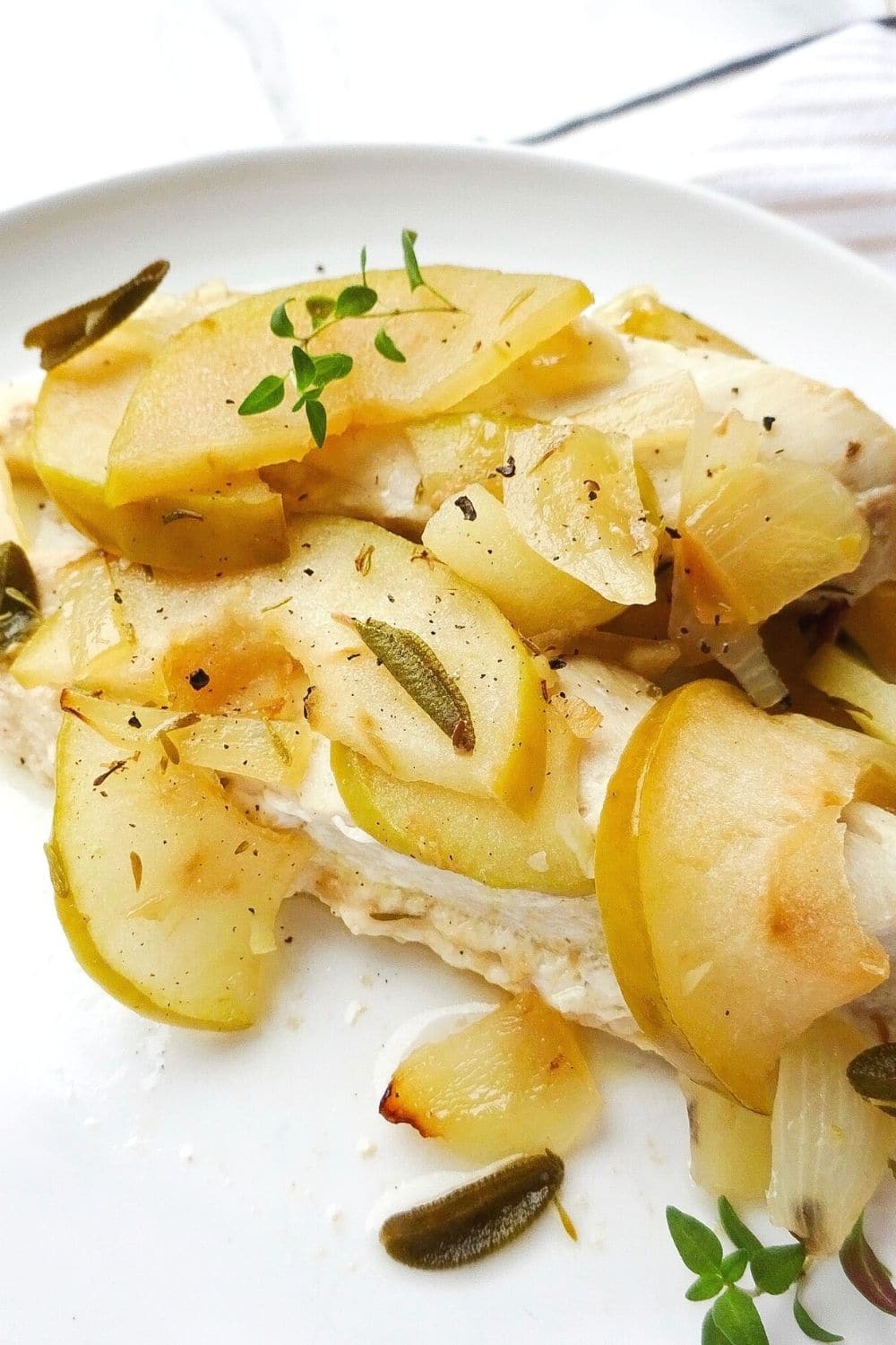 baked chicken with apple on a white plate