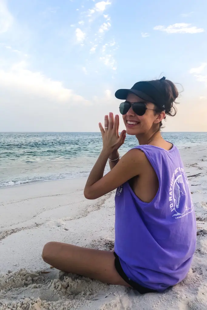woman meditating on the beach.