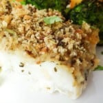 close up of Italian herb crusted cod on a white plate.