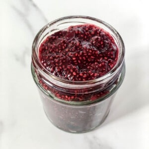 cherry chia jam in a glass jar.