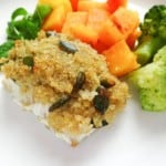 honey quinoa crusted cod on a white plate with broccoli and squash.