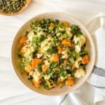 bowl of sweet potato couscous salad on a grey and white tea towel.
