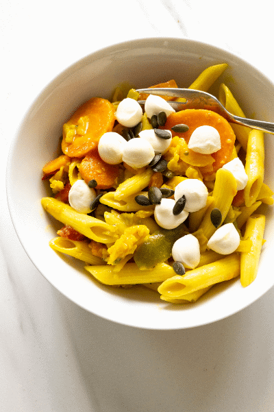 bowl of pasta vegetables and mozzarella.