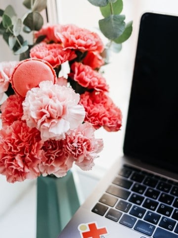 red roses next to a laptop
