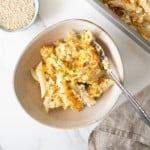 baked ricotta and butternut squash pasta in a brown bowl.