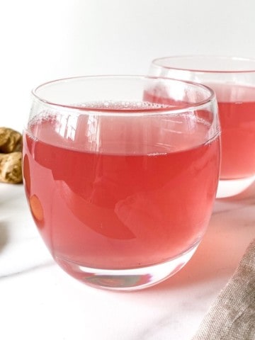 two glasses of pomegranate ginger tea.