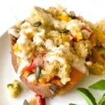 quinoa stuffed sweet potato on a white plate.