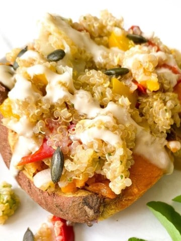 quinoa stuffed sweet potato on a white plate.