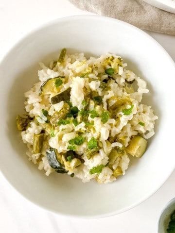 baked asparagus risotto in a white bowl.