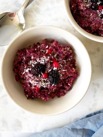 blackberry quinoa breakfast bake in two cream bowls.