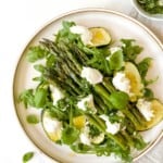 asparagus caprese salad on a brown plate.
