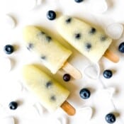 melon popsicles with blueberries on a white background.