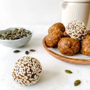 turmeric ginger energy balls with a jug in the background.