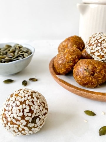 turmeric energy balls with a jug in the background.