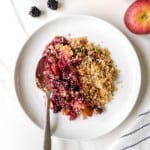 blackberry apple crisp on a white plate.