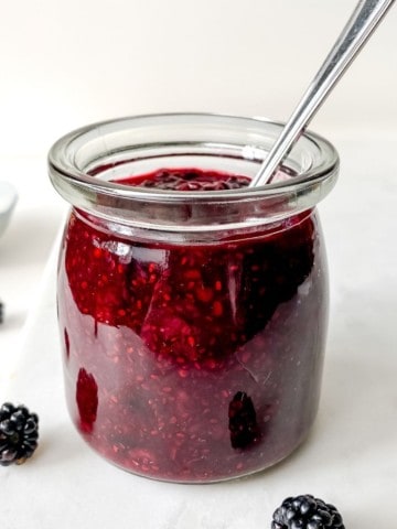 glass jar of blackberry chia jam.