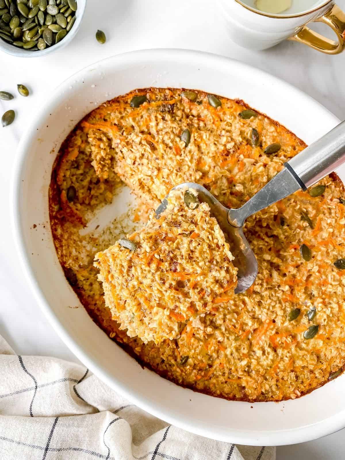 carrot cake baked oatmeal in a white ovenproof dish.
