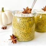pumpkin spice chia pudding in a glass jar with a white pumpkin in the background.