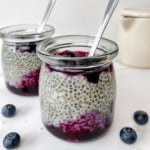 cardamom chia with blueberry compote in two glass jars.