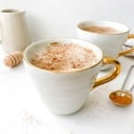 honey ginger warm milk in white cups with a jug in the background.