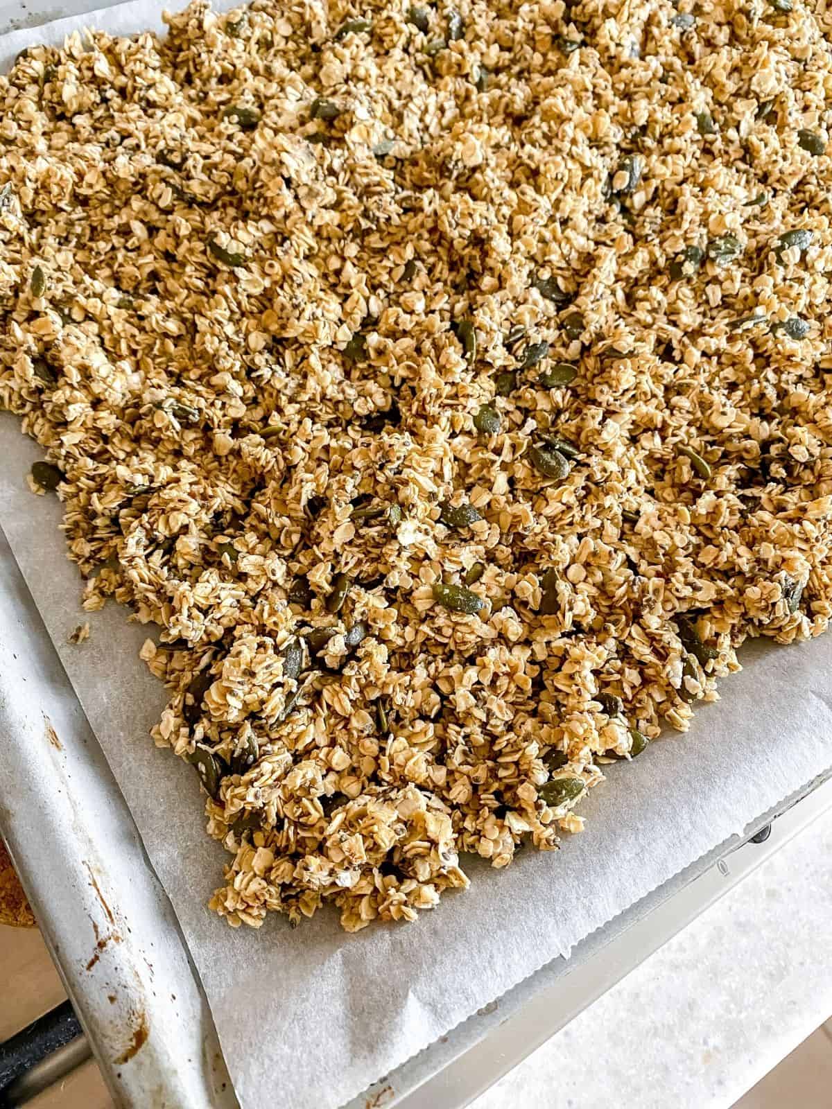 chia seed granola on a baking tray