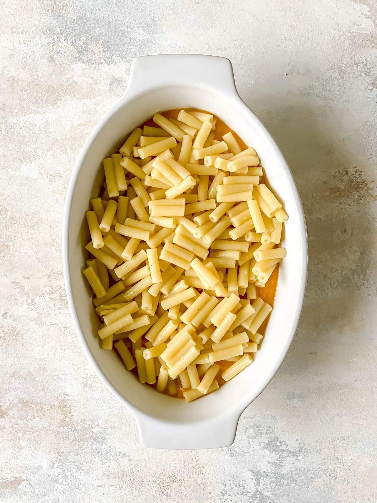 butternut squash sauce and pasta in a white dish.