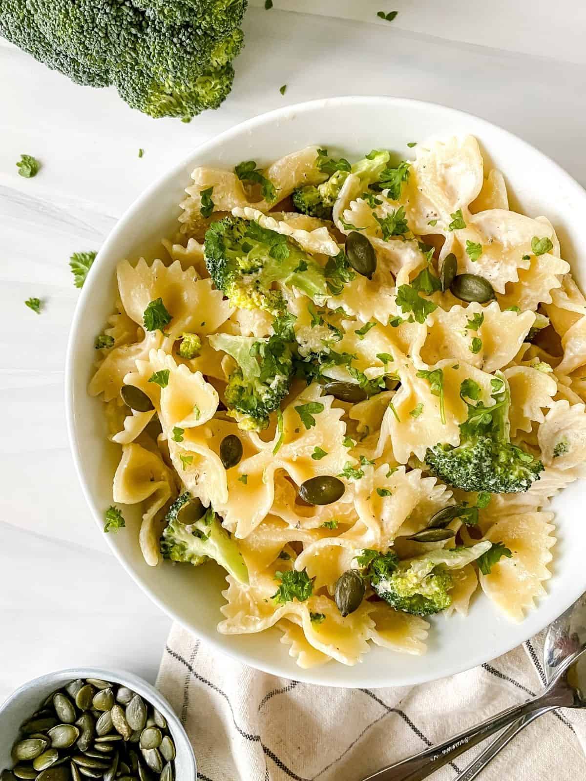 overhead view of tahini broccoli pasta in a white bowl.