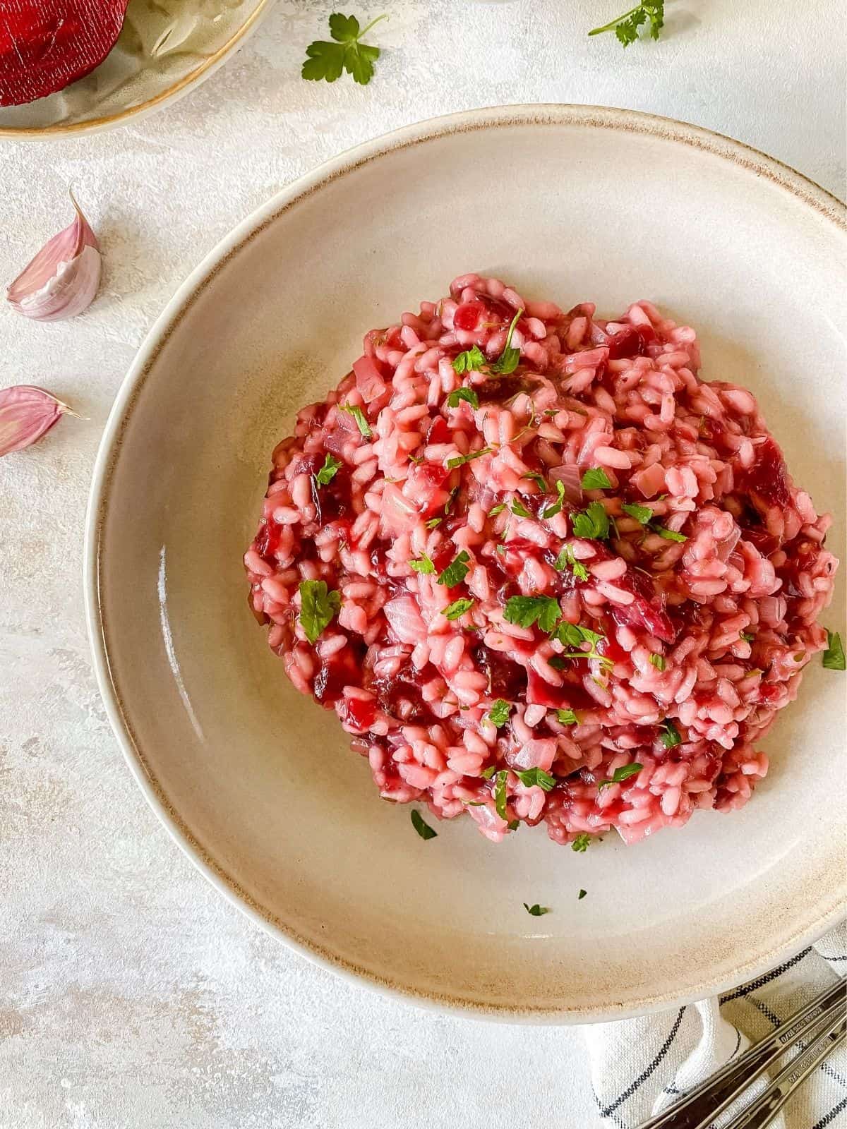 vegan beetroot risotto in a brown bowl.