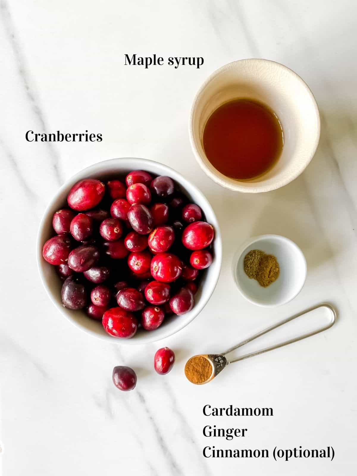 bowl of cranberries, maple syrup, cardamom, ginger and cinnamon.