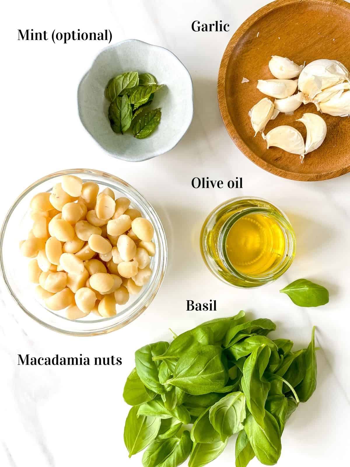 small bowls of mint, garlic, macadamia nuts, basil and olive oil.
