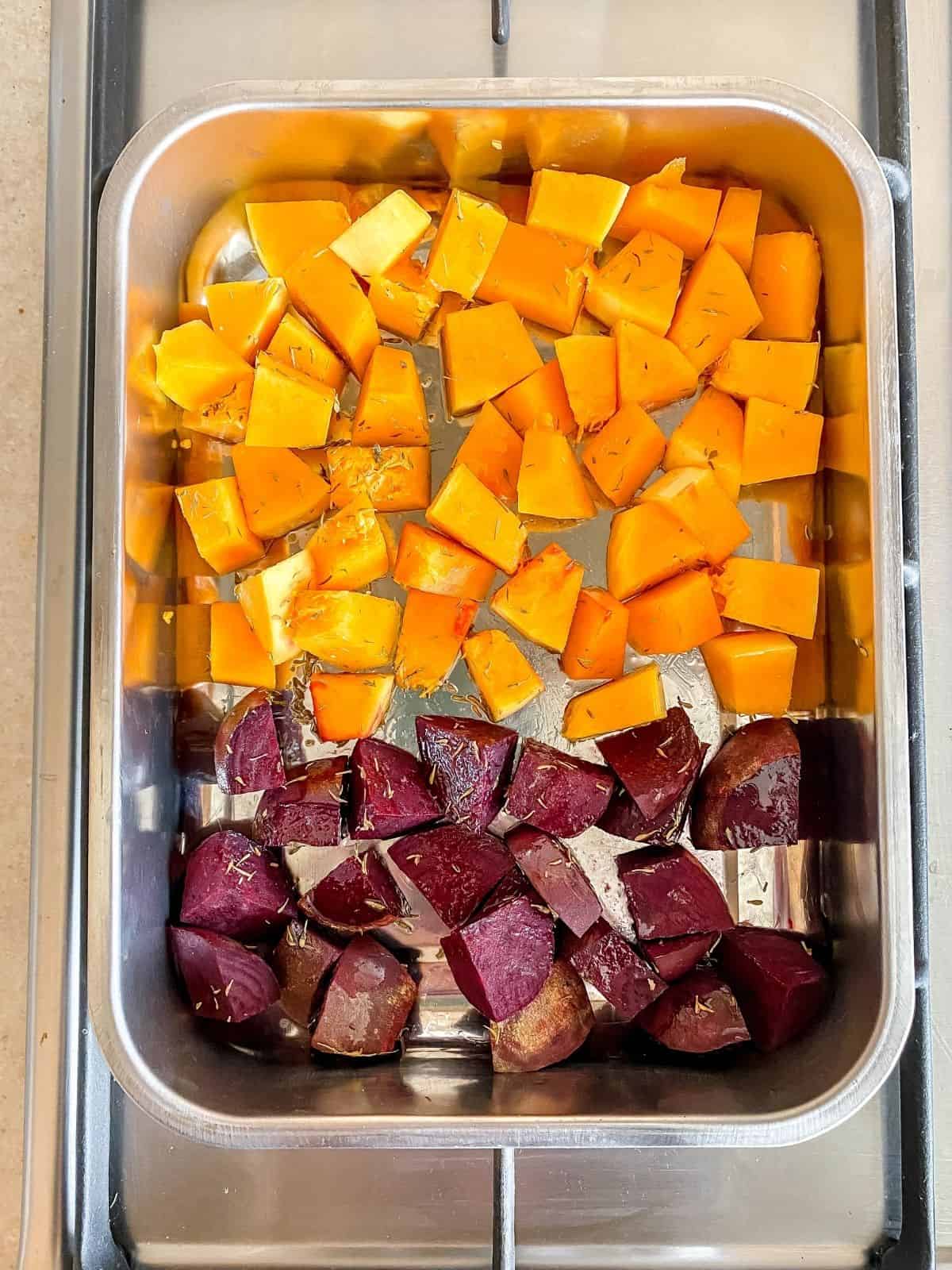 butternut squash and beetroot in a baking tray.