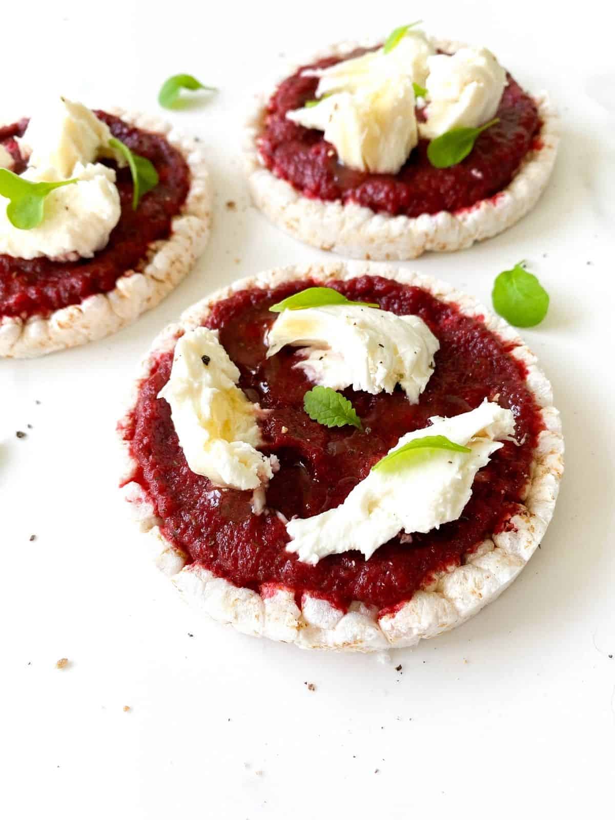 three beetroot and mozzarella topped rice cakes.