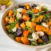 beetroot butternut squash salad in a cream bowl.