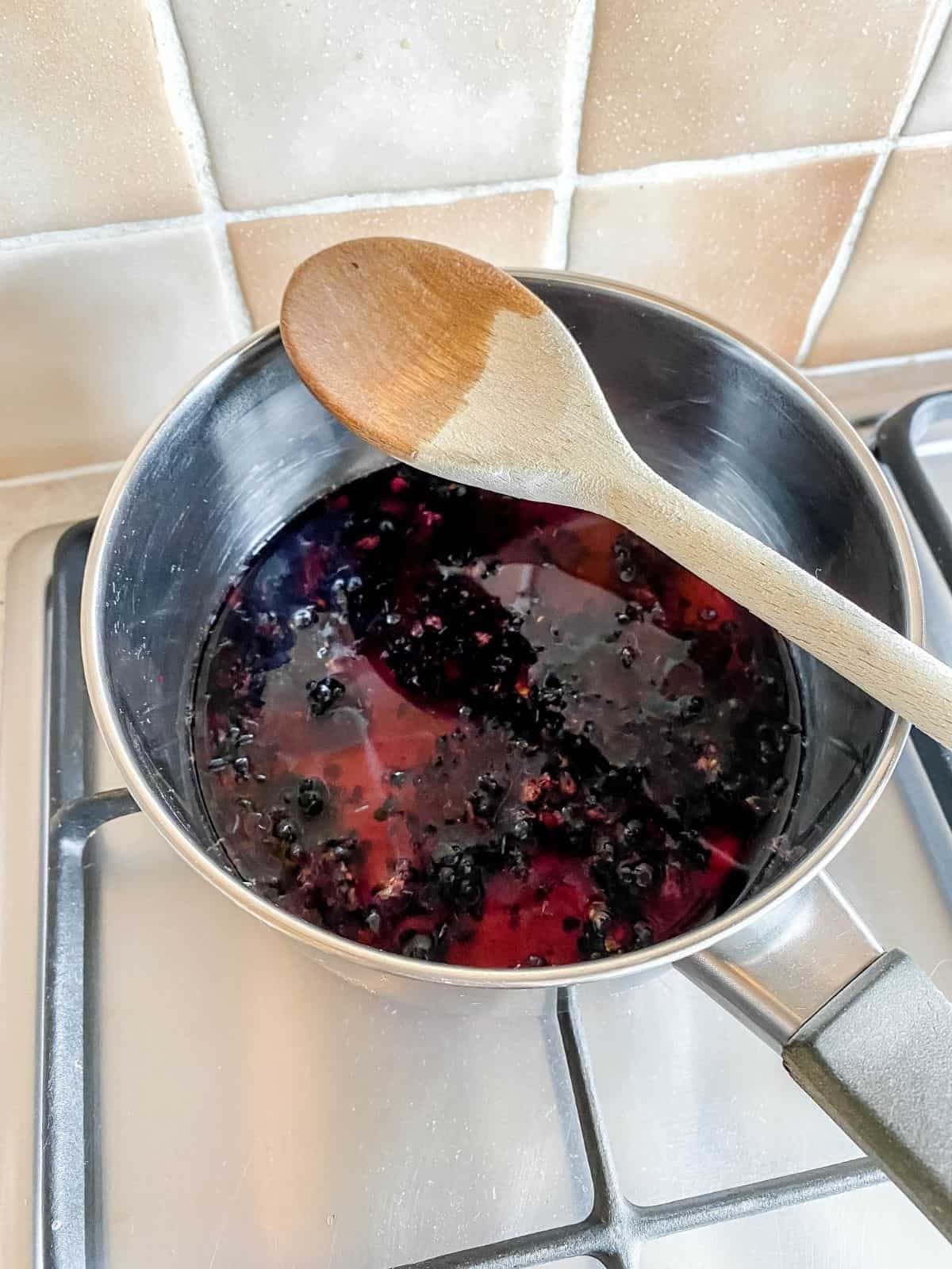 blackberries simmering in a pan.