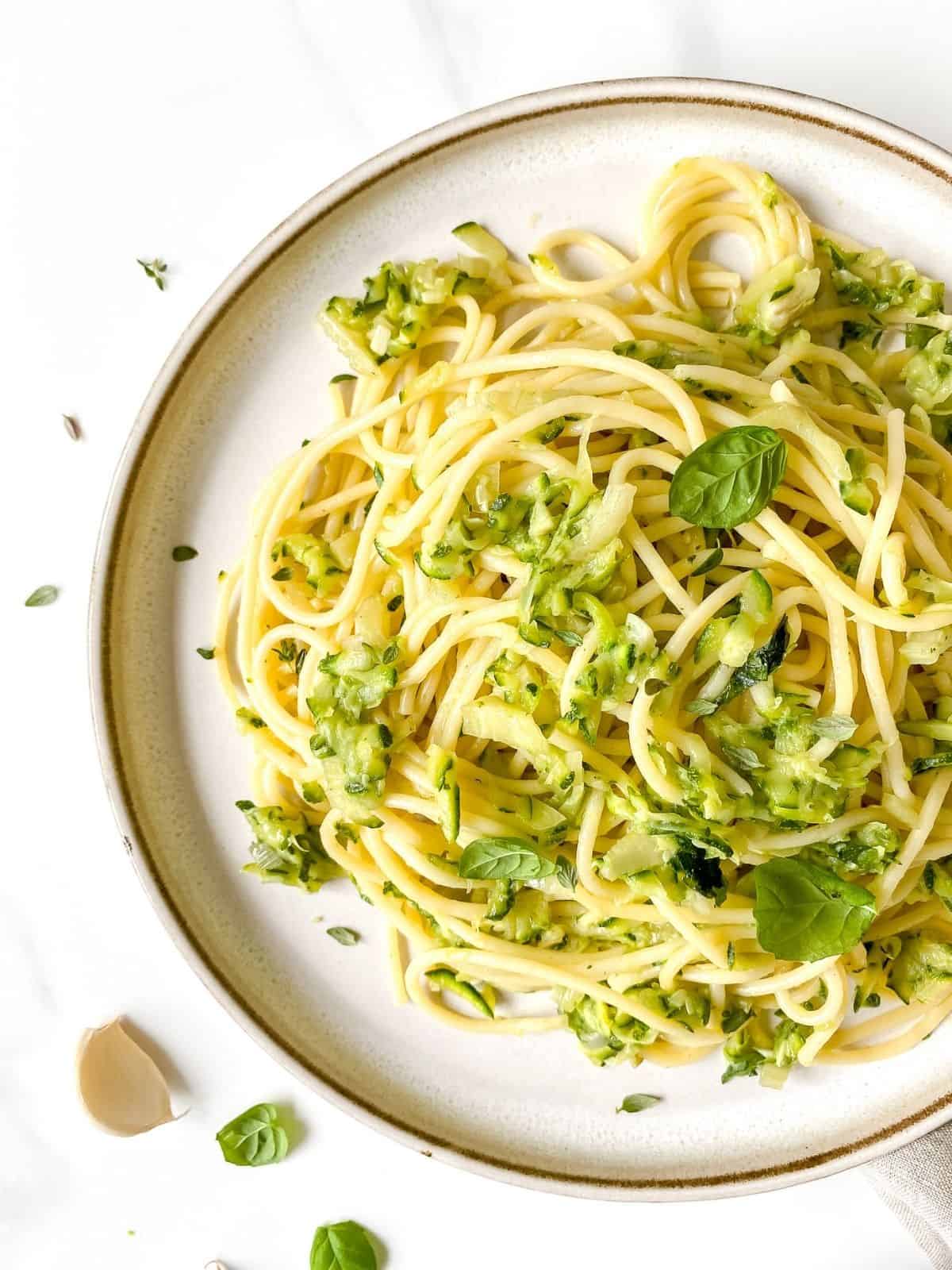 brown butter zucchini pasta on a brown plate.