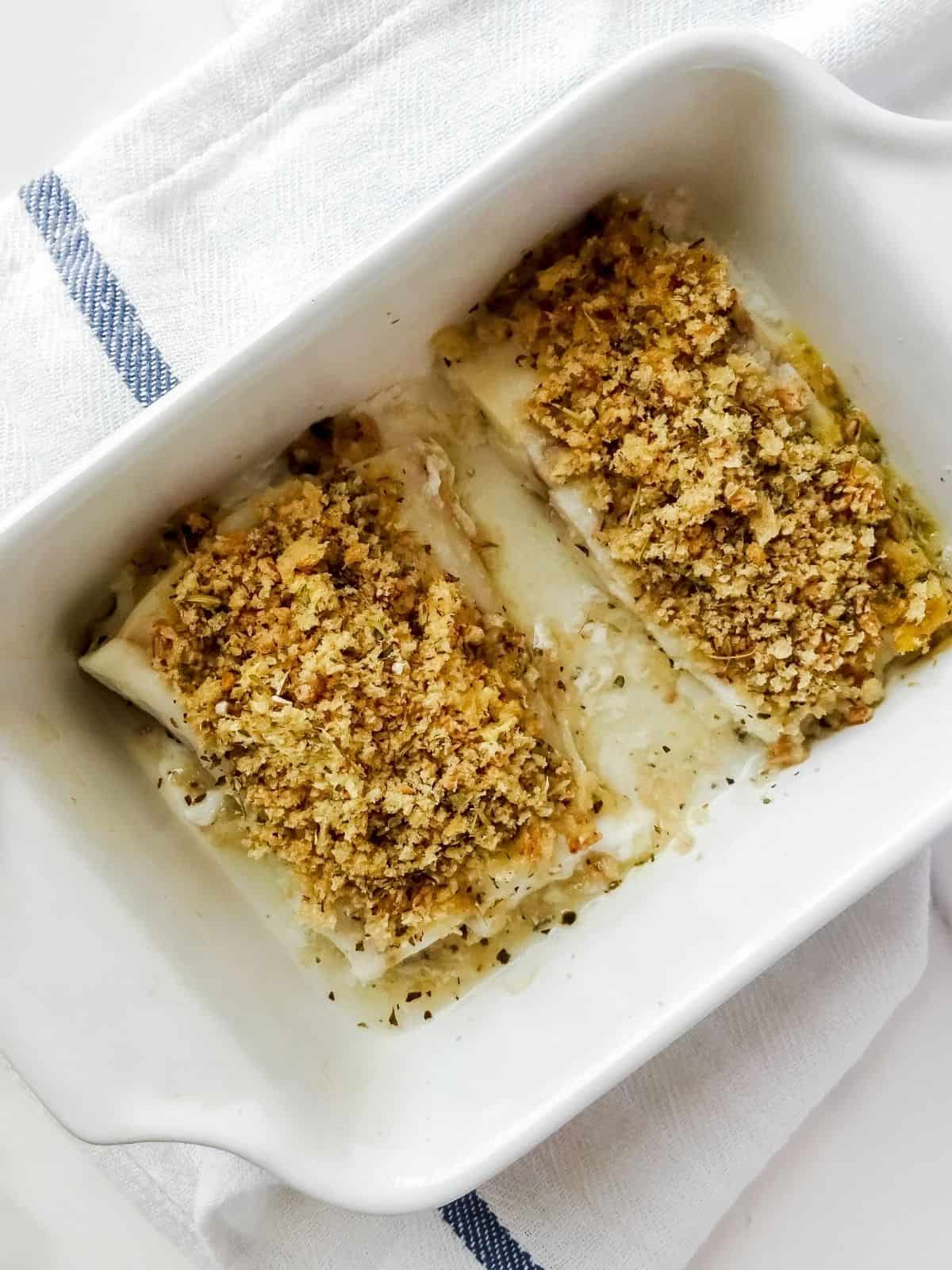 cod in a white baking dish with a herb crust.