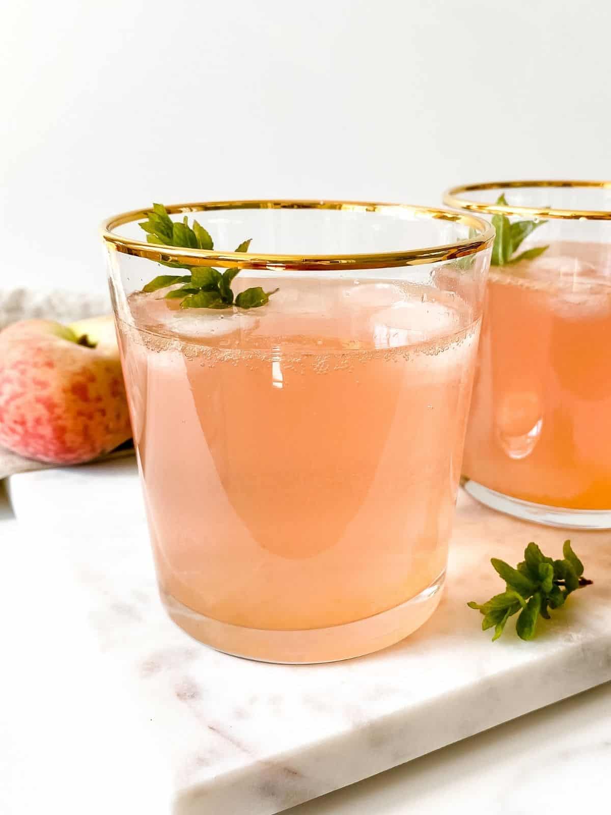 two glasses of peach honey mocktail.