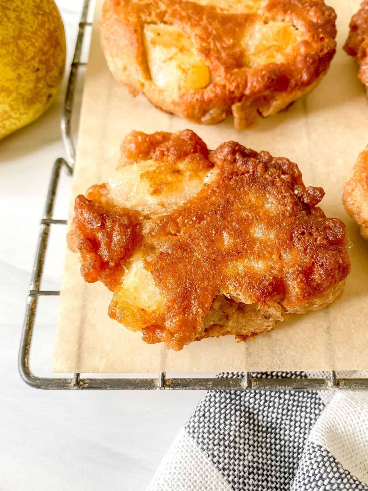 pear fritters on a wire rack on a striped cloth.