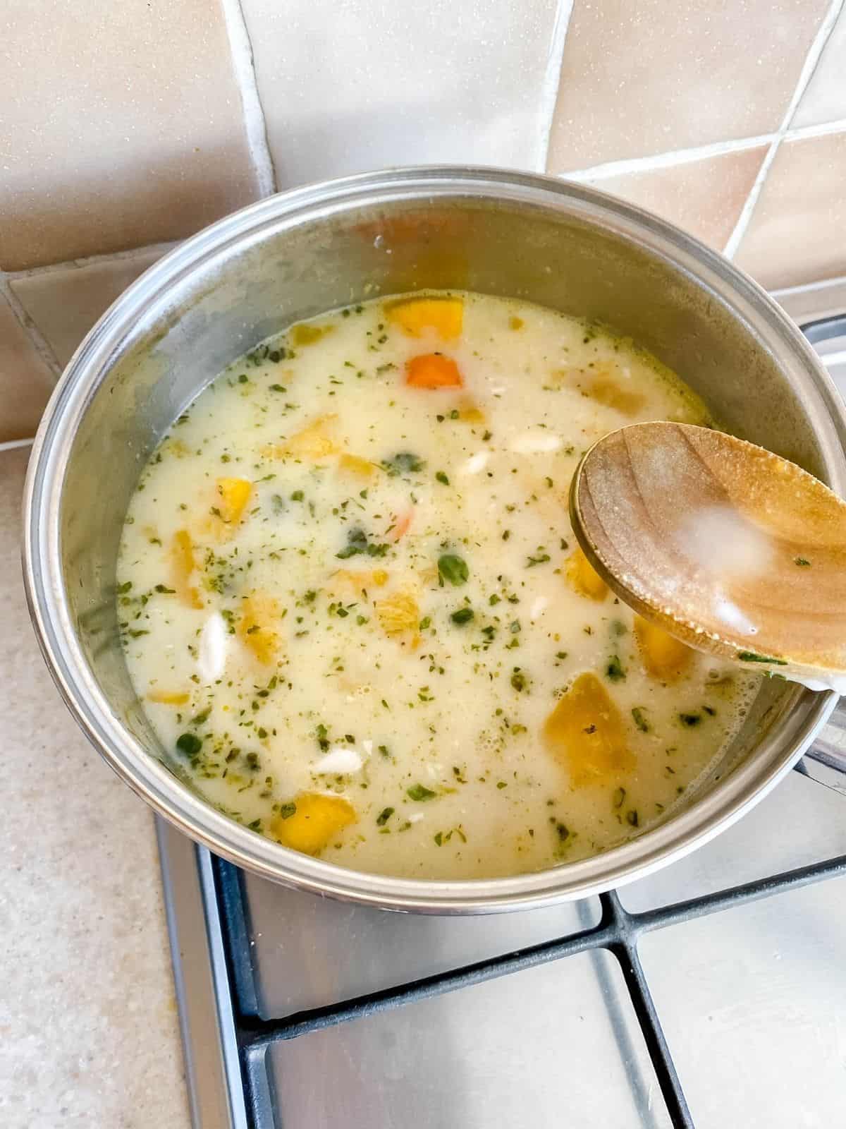 pumpkin soup ingredients in a pan.