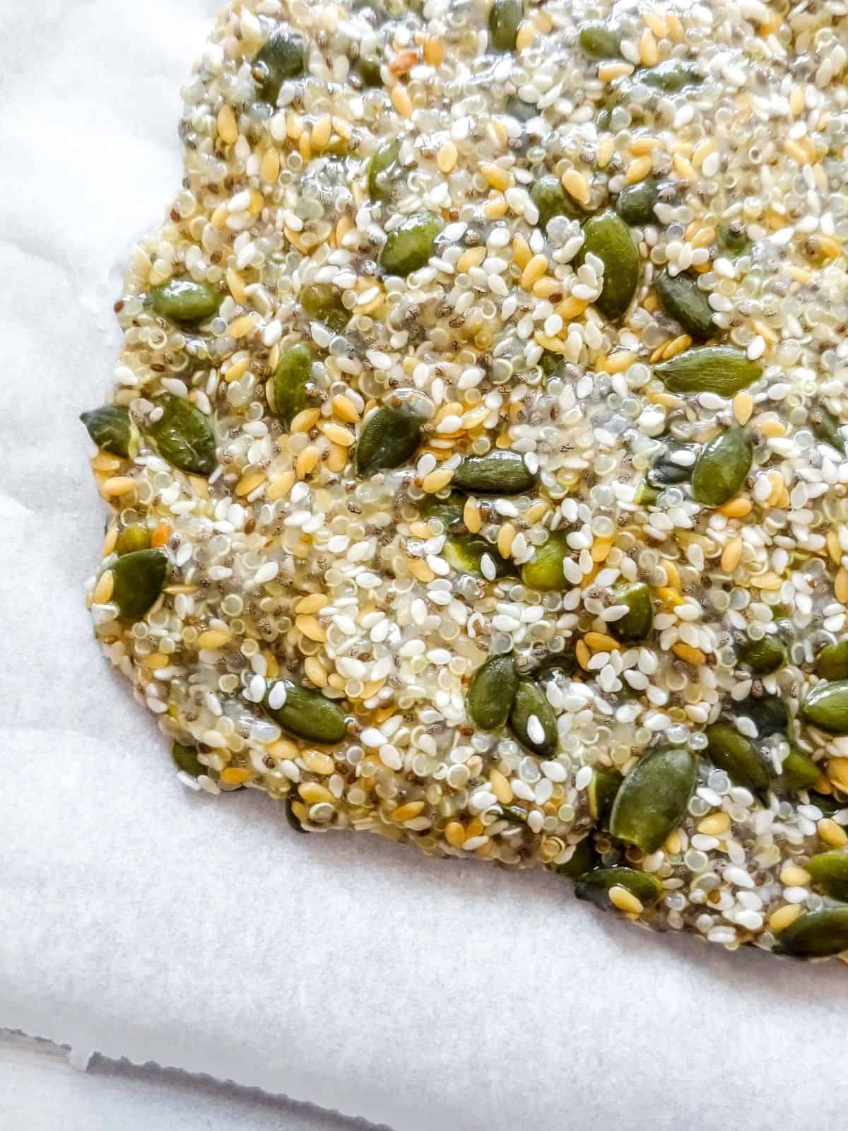 quinoa cracker mixture on a baking tray.