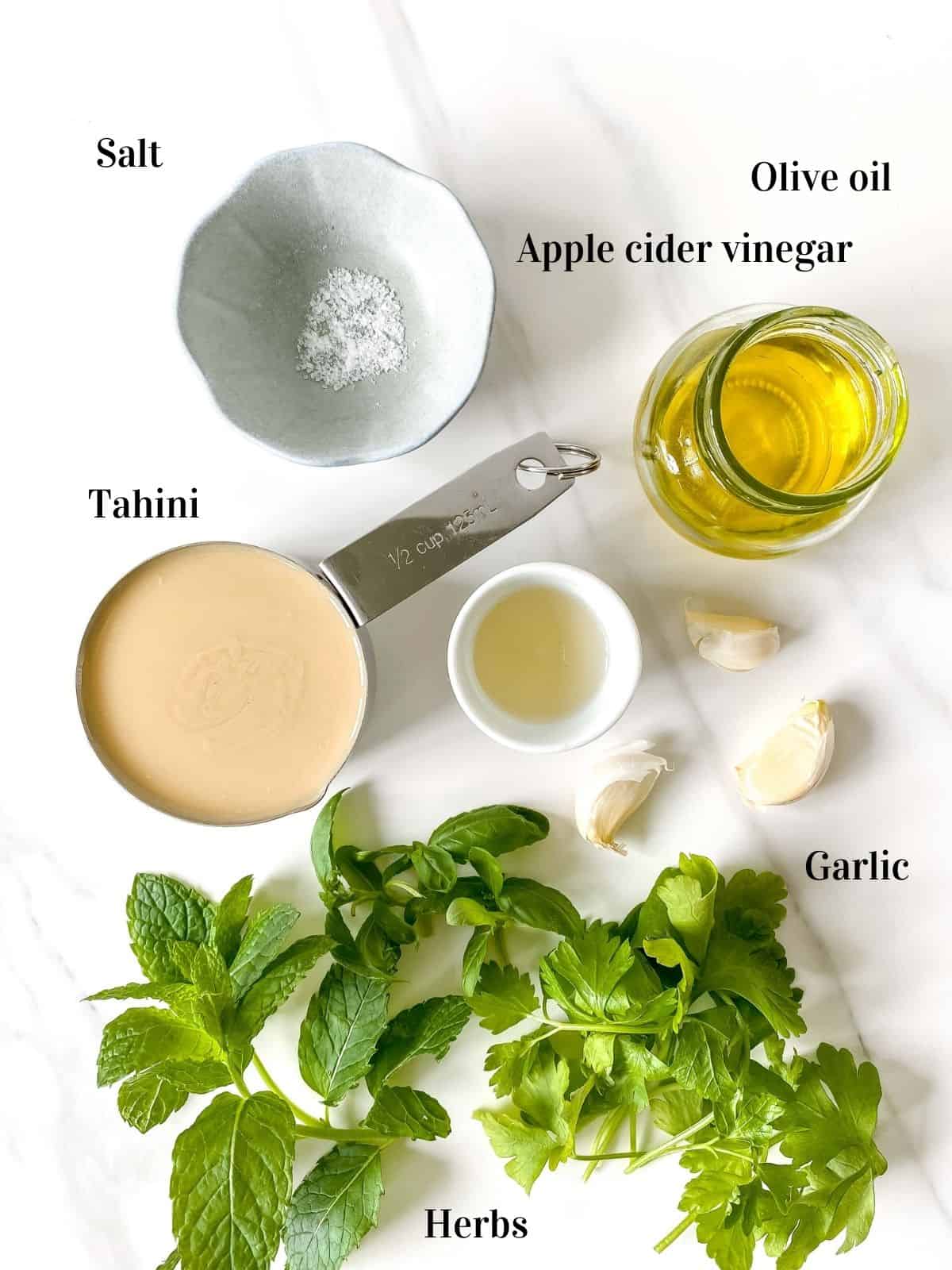 salt, olive oil, apple cider vinegar, tahini, garlic and fresh herbs.