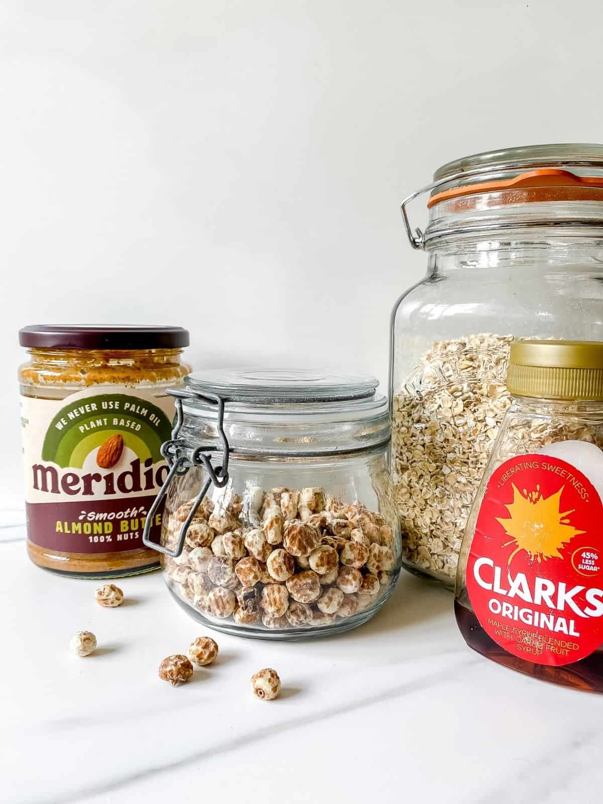 jars of tiger nuts, oats, almond butter and maple syrup.