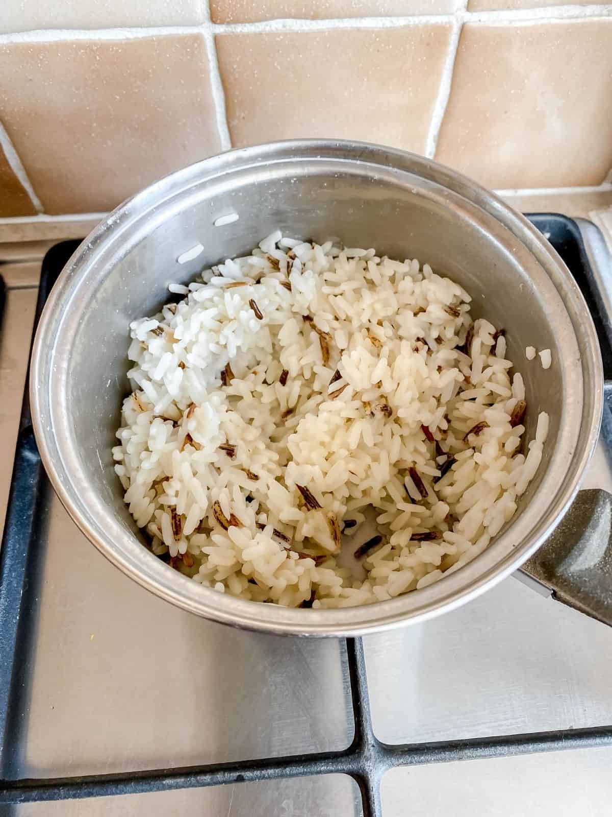 wild rice in a pan on a stove top.