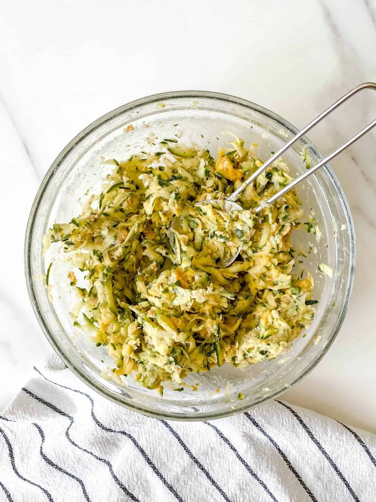 zucchini fritter mixture in a bowl.