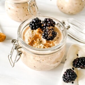 close up of a jar of cinnamon overnight oats with other jars in the background.