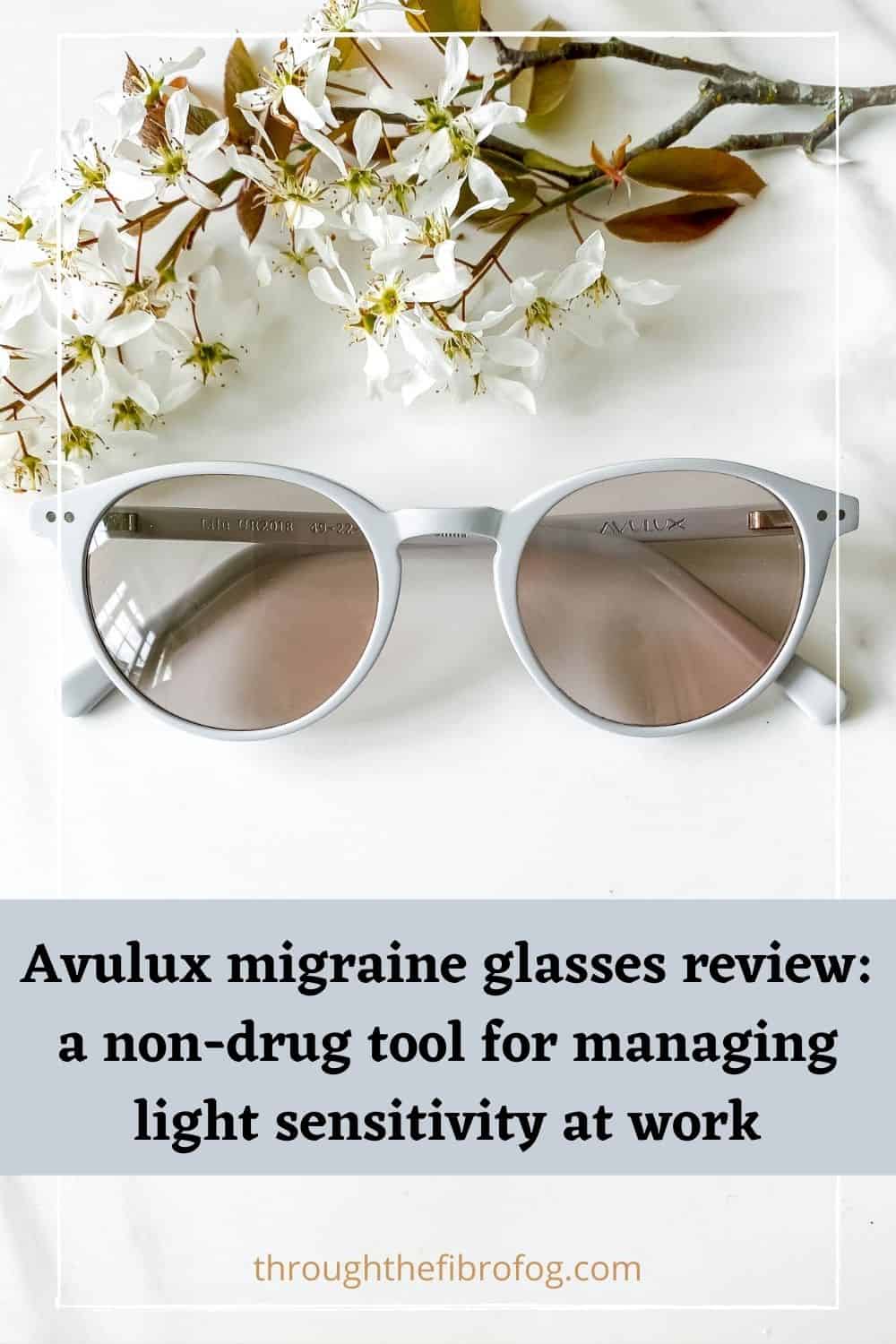 Avulux migraine glasses next to white flowers with text, Avulux migraine glasses review, a non-drug tool for managing light sensitivity at work, through the fibro fog dot com.