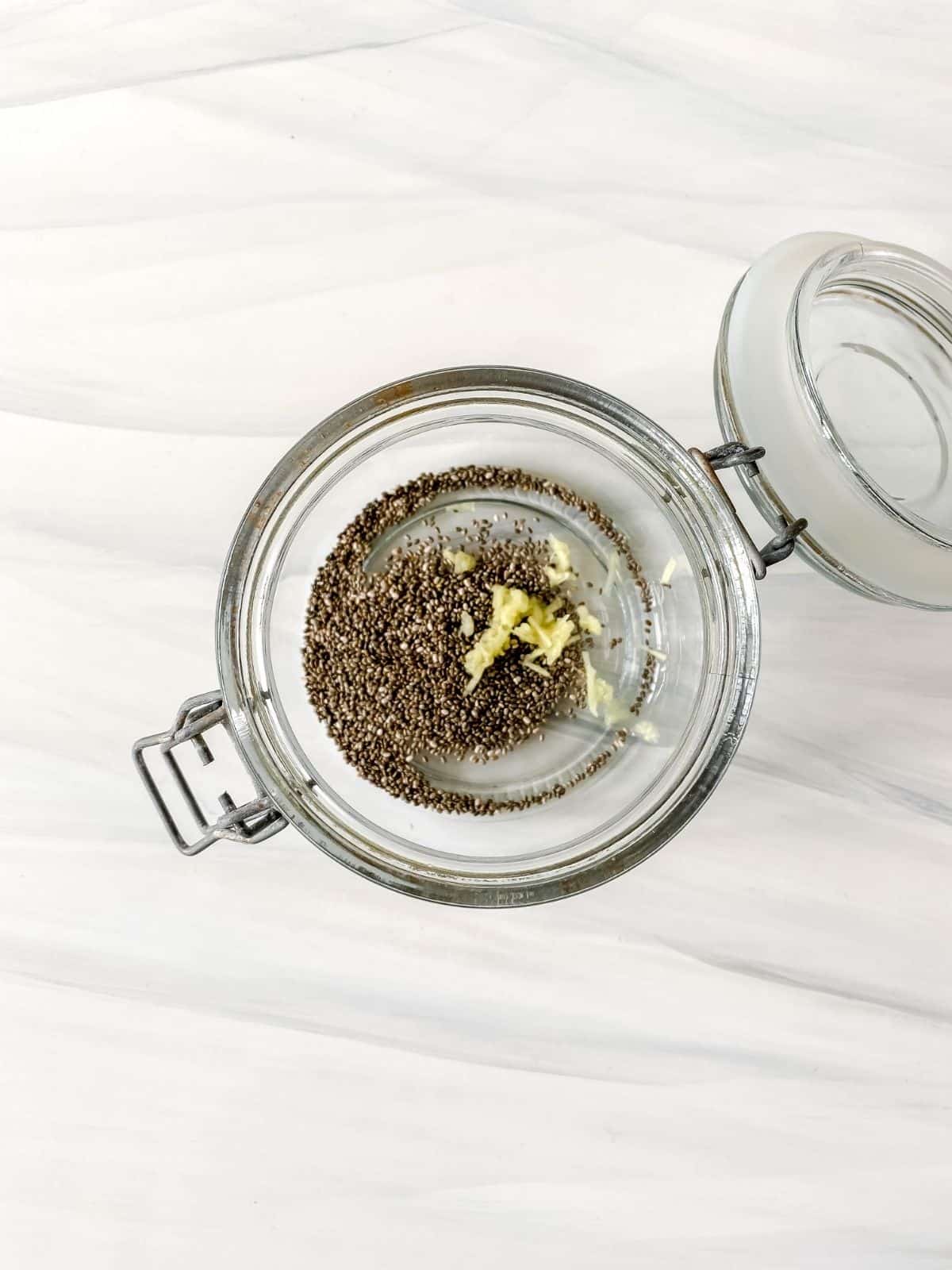 chia seeds and grated ginger in a glass jar.