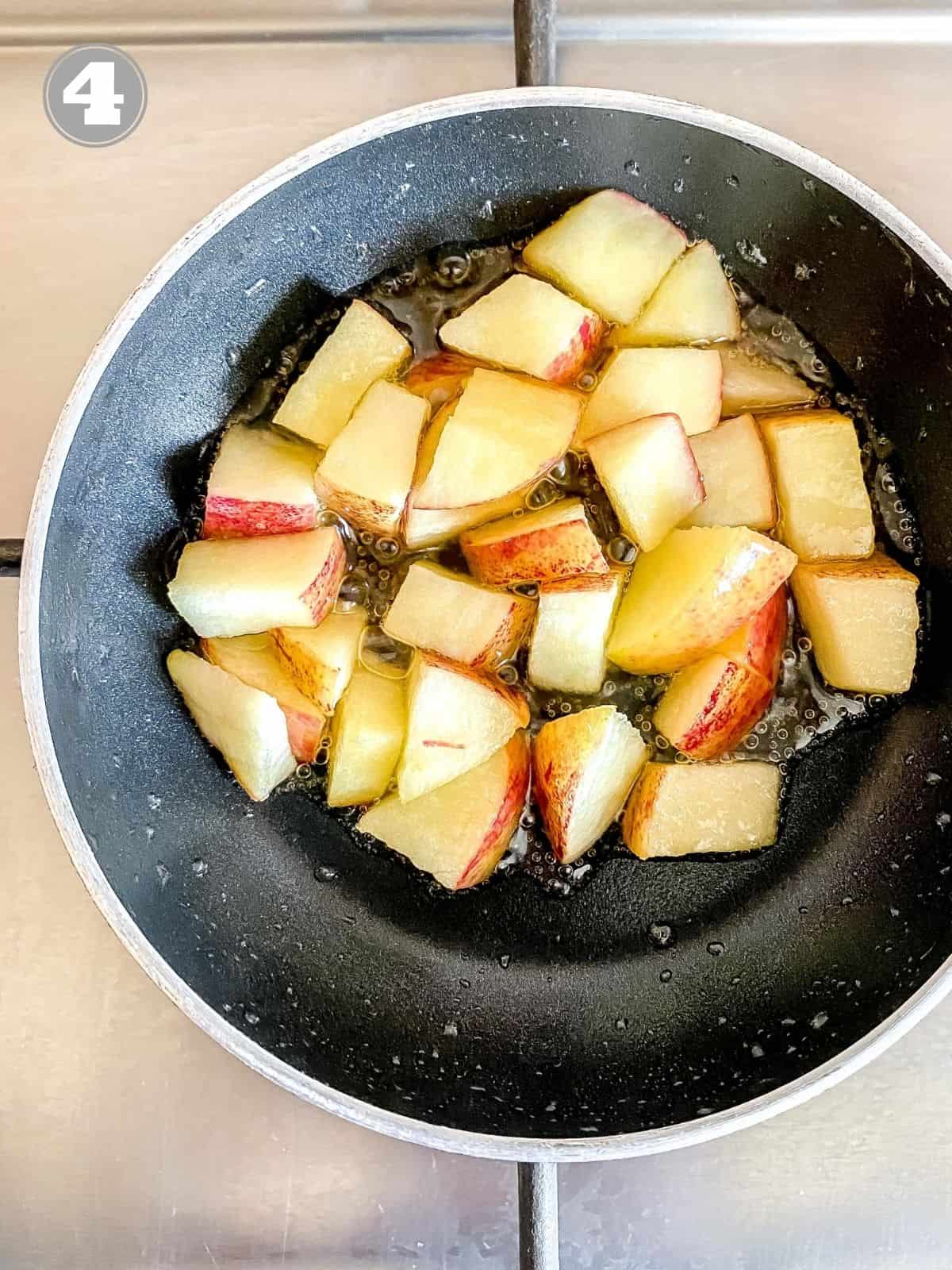 cubed apple pieces in a black pan.