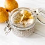 gingerbread chia pudding in a glass bowl with pears in the background.